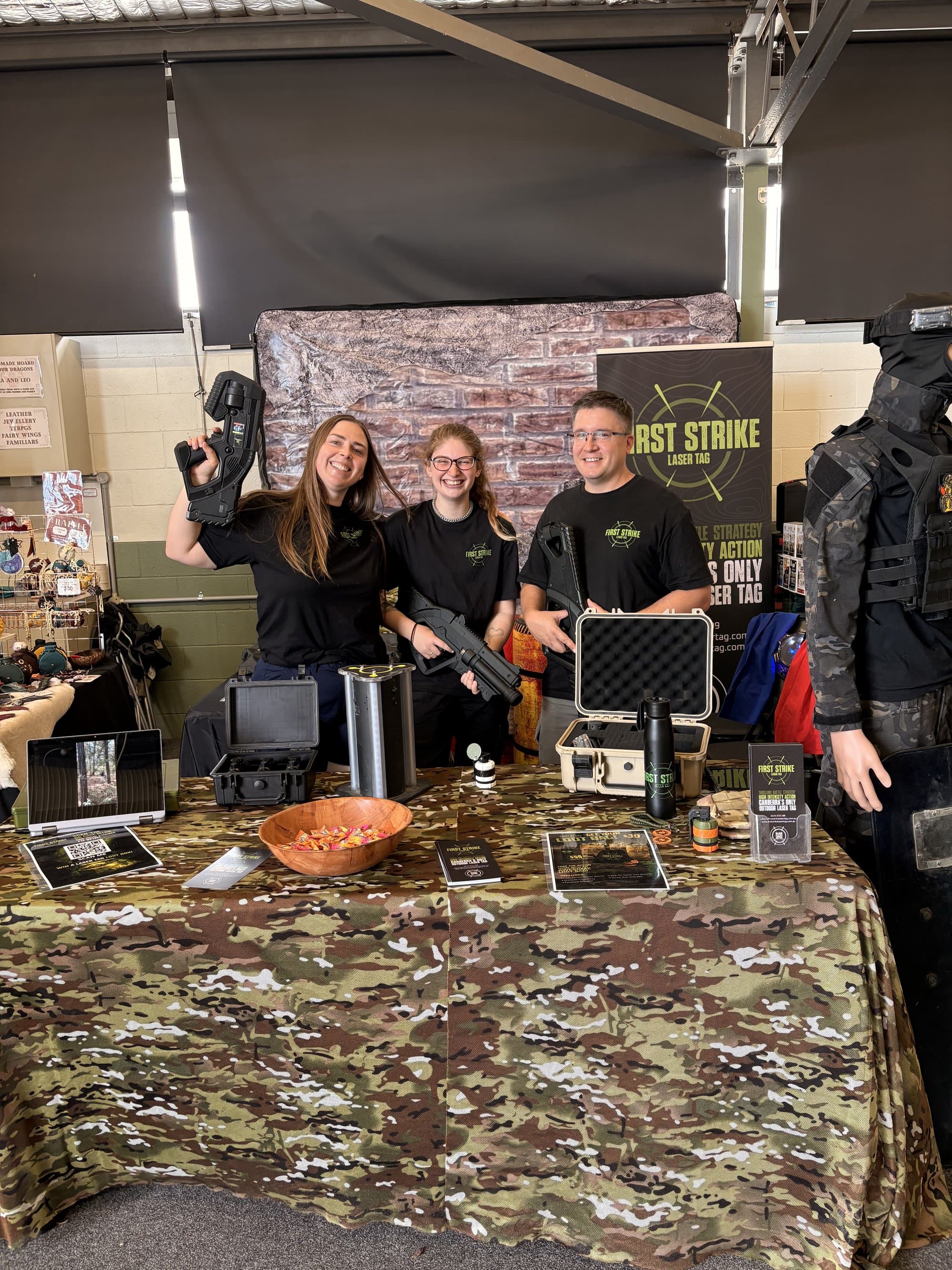FSLT team at an expo booth with gear on display